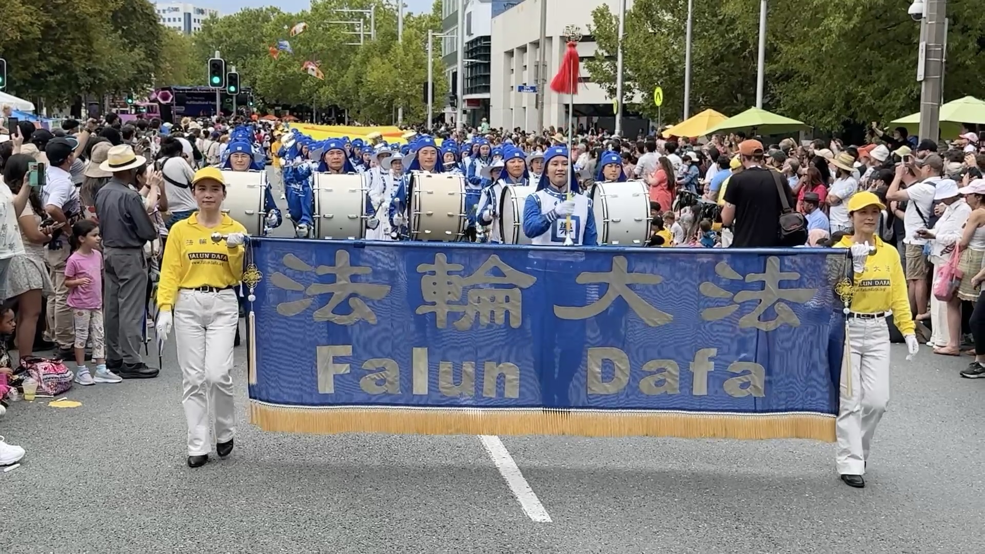 Tian Guo Marching Band drumline leading a parade past festival crowds in Canberra